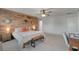 Large primary bedroom features a decorative wood accent wall and a ceiling fan at 1311 Berry Grove Dr, Summerville, SC 29485