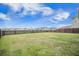 Large, grassy backyard enclosed by a dark wood fence, perfect for outdoor activities and privacy at 134 Lucca Dr, Summerville, SC 29486