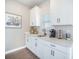 Coffee bar area with white cabinets, quartz countertops, and decor and black hardware at 134 Lucca Dr, Summerville, SC 29486