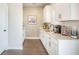Coffee bar area with white cabinets and appliances, quartz countertops and decor at 134 Lucca Dr, Summerville, SC 29486