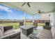 Outdoor covered patio with ceiling fans, cozy seating, and a grilling area, great for entertaining and relaxation at 134 Lucca Dr, Summerville, SC 29486