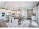 Dining room features a wooden table, modern lighting, white walls and views of the kitchen at 134 Lucca Dr, Summerville, SC 29486