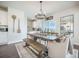 Light and bright dining room with rustic wooden table, neutral walls and views of the kitchen at 134 Lucca Dr, Summerville, SC 29486