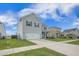 Traditional two-story home with gray siding, driveway, garage, and manicured lawn, offering classic curb appeal at 134 Lucca Dr, Summerville, SC 29486