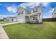 Beautifully landscaped front yard with lush green grass leading to a welcoming home and a neatly edged flower bed at 134 Lucca Dr, Summerville, SC 29486