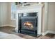 Cozy living room fireplace with a black interior and a white mantel against beige colored walls at 134 Lucca Dr, Summerville, SC 29486