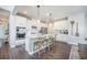 A large kitchen island with white cabinets, stainless appliances and wood laminate flooring at 134 Lucca Dr, Summerville, SC 29486
