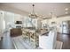 Open-concept living space featuring a fireplace, dining area, and modern kitchen with white cabinets at 134 Lucca Dr, Summerville, SC 29486
