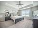 Spacious main bedroom with tray ceiling, ceiling fan, and large windows with bright natural light at 134 Lucca Dr, Summerville, SC 29486
