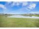 Scenic view of a tranquil pond surrounded by lush green grass and neighborhood homes at 134 Lucca Dr, Summerville, SC 29486