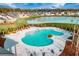 Aerial view of a community pool with lounge chairs and umbrellas, adjacent to a lake surrounded by upscale homes at 134 Lucca Dr, Summerville, SC 29486