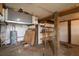 Unfinished basement with shelving, hot water tank, wooden support beams, and unfinished walls at 1404 Palmetto Blvd, Edisto Beach, SC 29438