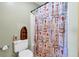 Small bathroom featuring a toilet and a shower with a decorative curtain at 1404 Palmetto Blvd, Edisto Beach, SC 29438