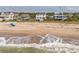 Beautiful beach scene showing the ocean and the homes along the shoreline at 1404 Palmetto Blvd, Edisto Beach, SC 29438