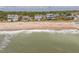 Beautiful beachfront homes line the shore with gentle waves lapping at the sandy beach at 1404 Palmetto Blvd, Edisto Beach, SC 29438