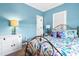 Bright bedroom with light-blue walls, ornate bedding, and comfortable carpeting at 1404 Palmetto Blvd, Edisto Beach, SC 29438