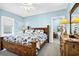 Inviting bedroom with a ceiling fan, neutral walls, carpet, and a wooden bed frame at 1404 Palmetto Blvd, Edisto Beach, SC 29438