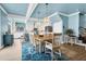 Light-filled dining room connects to a kitchen with a large island and modern pendant lighting at 1404 Palmetto Blvd, Edisto Beach, SC 29438