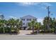 This house has a beautiful brick driveway with palm trees and mature landscaping at 1404 Palmetto Blvd, Edisto Beach, SC 29438