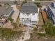 Coastal home with a large deck, private beach access, fenced yard, and lush landscaping at 1404 Palmetto Blvd, Edisto Beach, SC 29438