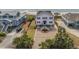 Well-maintained home with a paved driveway, fenced yard, and landscaped front garden at 1404 Palmetto Blvd, Edisto Beach, SC 29438