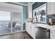 This kitchen has white cabinets, modern appliances, and a sliding door to a patio at 1404 Palmetto Blvd, Edisto Beach, SC 29438