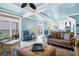 Cozy living room with an ottoman, stylish furnishings, and sliders to a porch at 1404 Palmetto Blvd, Edisto Beach, SC 29438