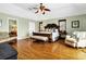 Spacious main bedroom features hardwood floors, and an en suite bathroom at 1404 Palmetto Blvd, Edisto Beach, SC 29438