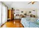 Bright bedroom with wood floors, natural light, ceiling fan, and coastal-inspired decor at 1404 Palmetto Blvd, Edisto Beach, SC 29438