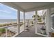 Relax on the covered porch with amazing views of the beach and ocean at 1404 Palmetto Blvd, Edisto Beach, SC 29438