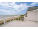 Rooftop deck with white railings providing panoramic ocean views at 1404 Palmetto Blvd, Edisto Beach, SC 29438