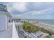 Roof deck with beach views and white railing overlooking a sandy shoreline at 1404 Palmetto Blvd, Edisto Beach, SC 29438