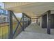 Spacious underneath of deck with gray support beams, black iron fence, and a peek of the ocean at 1404 Palmetto Blvd, Edisto Beach, SC 29438