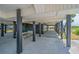 View of picnic table beneath the raised home and shaded parking at 1404 Palmetto Blvd, Edisto Beach, SC 29438