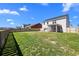 Large fenced backyard with lawn, patio, and covered porch, perfect for outdoor entertaining and relaxation at 142 Lucca Dr, Summerville, SC 29486