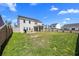 Large backyard featuring green grass, privacy fence, patio and screened porch with lawn furniture at 142 Lucca Dr, Summerville, SC 29486