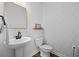 Chic powder room features a modern pedestal sink, stylish mirror, and decorative wallpaper at 142 Lucca Dr, Summerville, SC 29486