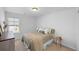 Comfortable bedroom featuring a queen bed, side table, and dresser with natural light from the window at 142 Lucca Dr, Summerville, SC 29486