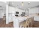 Modern white kitchen features a large island, stainless steel appliances, and stylish pendant lighting at 142 Lucca Dr, Summerville, SC 29486