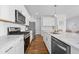 Bright kitchen features stainless appliances, white cabinets, and a stone countertop at 142 Lucca Dr, Summerville, SC 29486