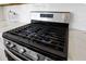 Close-up shot of a stainless steel stove with gas burners and white tile backsplash at 142 Lucca Dr, Summerville, SC 29486