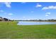 Scenic view of a tranquil pond surrounded by lush green grass, offering a peaceful and serene setting at 142 Lucca Dr, Summerville, SC 29486