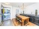 Bright dining room with a wood table, elegant chandelier, and decorative display cabinet at 1571 Blaze Ln, Charleston, SC 29412