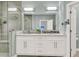 Bright bathroom features a double sink vanity with marble countertops and a glass-enclosed shower at 1733 James Basford Pl, Mount Pleasant, SC 29466
