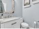 Well-lit powder room with a vanity, framed mirror, and fixtures at 1733 James Basford Pl, Mount Pleasant, SC 29466