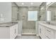 Elegant bathroom with a glass shower enclosure and marble countertops on a double vanity at 1733 James Basford Pl, Mount Pleasant, SC 29466