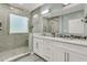 Modern bathroom with double sink vanity, stone countertops, and a glass-enclosed shower for a spa-like feel at 1733 James Basford Pl, Mount Pleasant, SC 29466