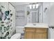 The bathroom is equipped with a toilet, sink, vanity, mirror, and shower curtain showcasing its functionality at 1733 James Basford Pl, Mount Pleasant, SC 29466