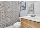 Bathroom with a vanity, toilet, patterned shower curtain, and decorative wall art at 1733 James Basford Pl, Mount Pleasant, SC 29466