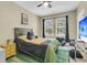 Cozy bedroom with hardwood floors, ceiling fan, a themed rug, and natural light from the window at 1733 James Basford Pl, Mount Pleasant, SC 29466